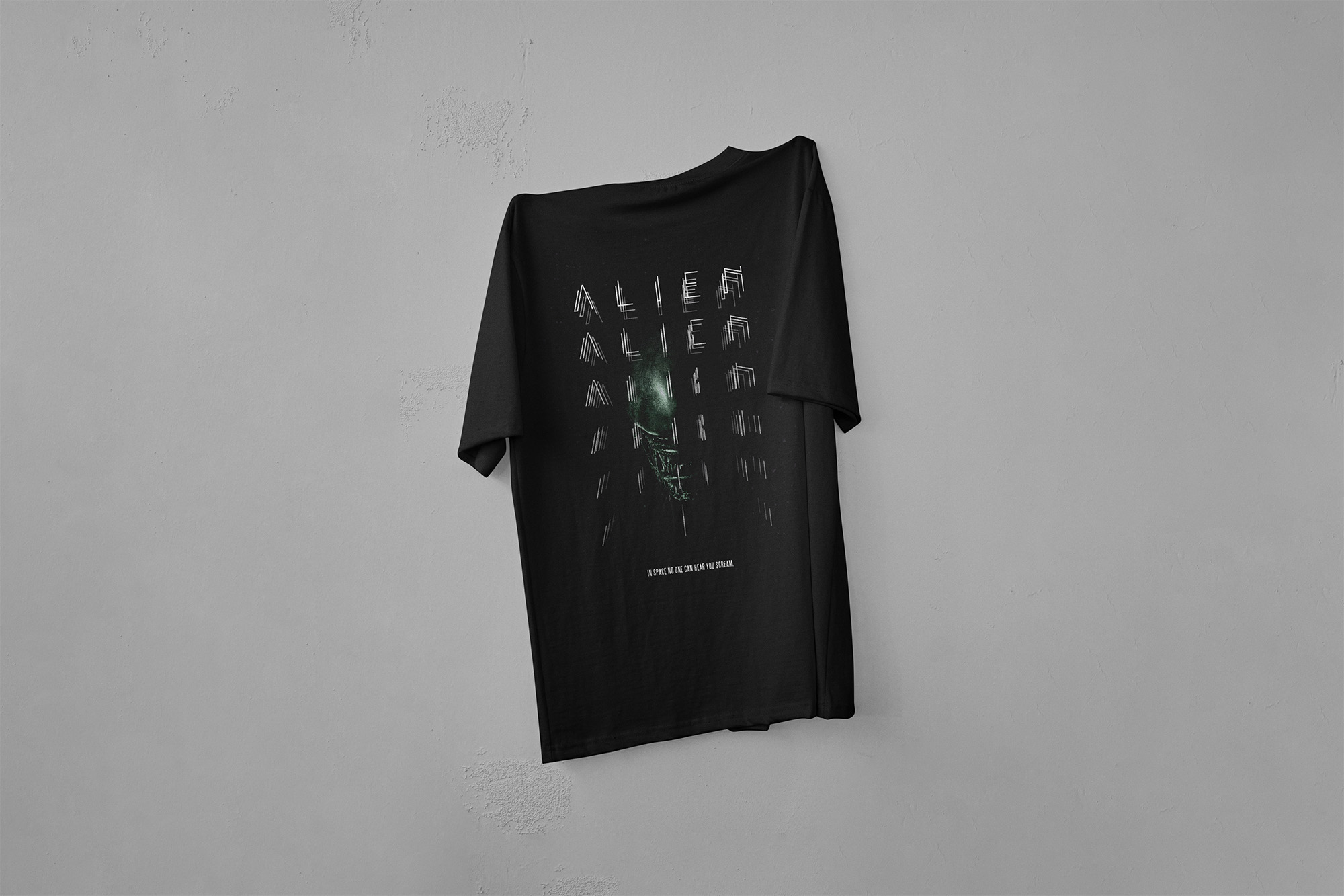 Dark T-shirt that says "Alien" in front of a Xenomorph creature from the "Alien" movie, featured on a white background